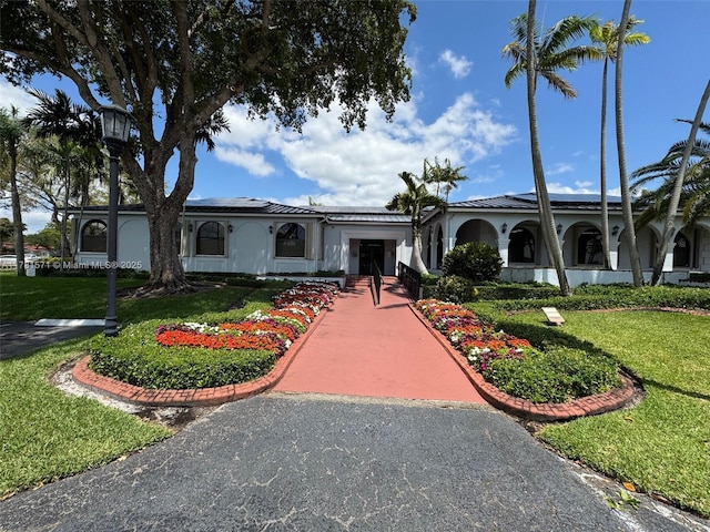 17012 NW 66th Ct, Hialeah, FL 33015 - view of front of property featuring stucco siding, a front lawn, and driveway