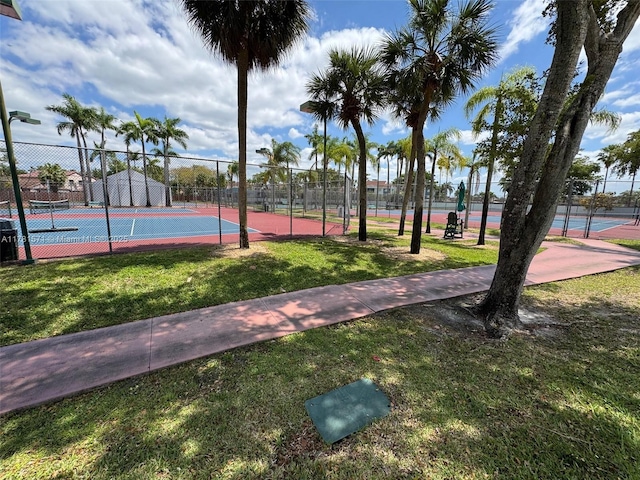17012 NW 66th Ct, Hialeah, FL 33015 - view of sport court featuring a lawn and fence