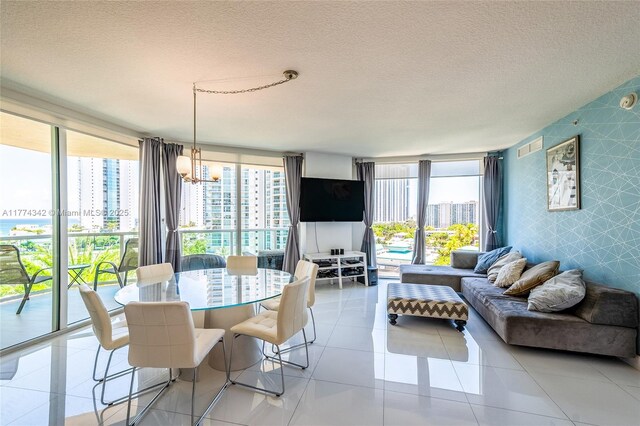 250 Sunny Isles Blvd Unit 3-805, Sunny Isles Beach, FL 33160 - living room featuring a chandelier, plenty of natural light, a textured ceiling, a wall of windows, and light tile patterned floors