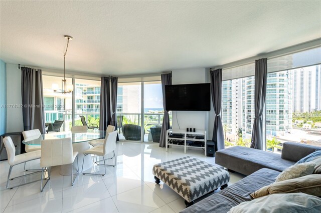 250 Sunny Isles Blvd Unit 3-805, Sunny Isles Beach, FL 33160 - living room with a chandelier, tile patterned flooring, a wall of windows, and a textured ceiling