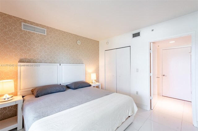 250 Sunny Isles Blvd Unit 3-805, Sunny Isles Beach, FL 33160 - tiled bedroom featuring wallpapered walls and a closet