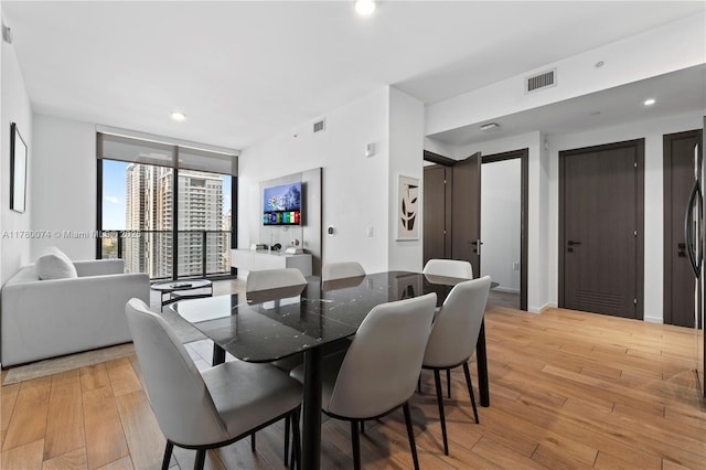 398 NE 5th St Unit 2119, Miami, FL 33132 - dining room featuring light wood finished floors, floor to ceiling windows, visible vents, and recessed lighting