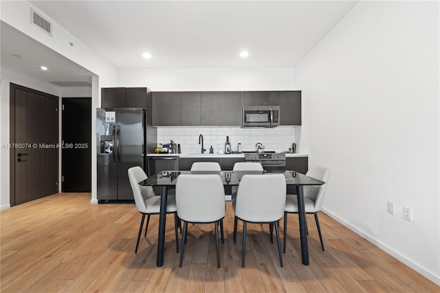 398 NE 5th St Unit 2119, Miami, FL 33132 - dining area with recessed lighting, visible vents, light wood-type flooring, and baseboards