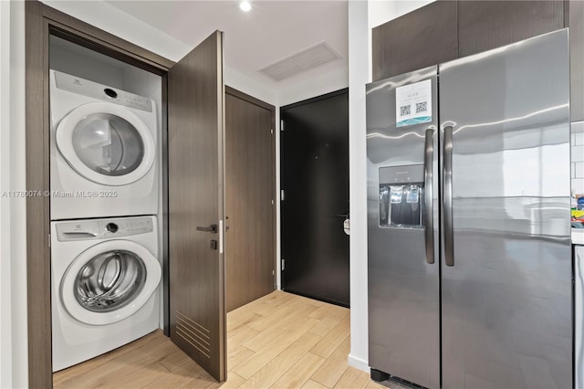 398 NE 5th St Unit 2119, Miami, FL 33132 - clothes washing area featuring visible vents, laundry area, light wood-type flooring, and stacked washer / drying machine