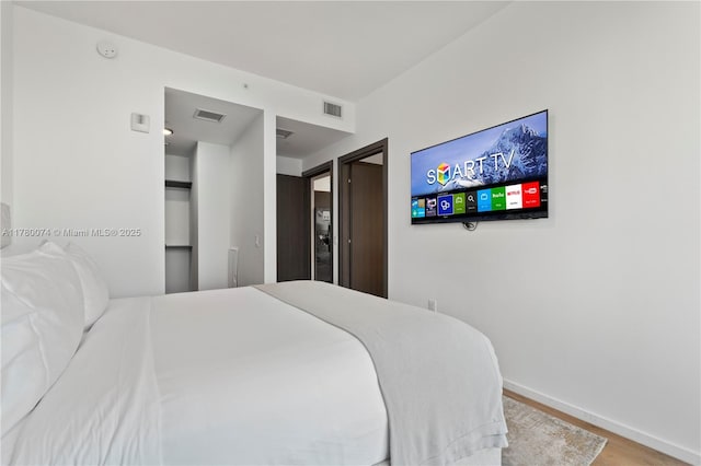398 NE 5th St Unit 2119, Miami, FL 33132 - bedroom featuring visible vents, baseboards, and wood finished floors