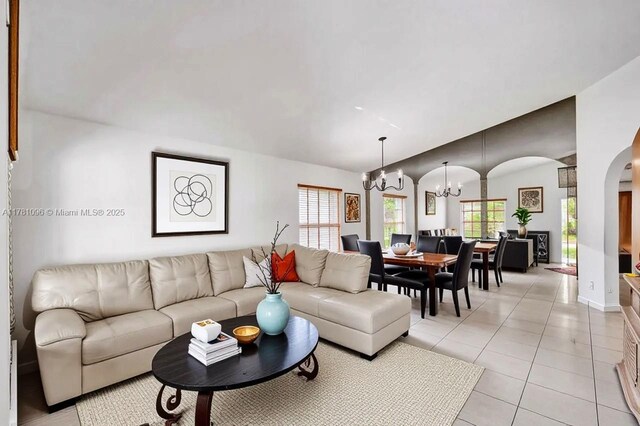 11410 SW 20th St, Miramar, FL 33025 - living area featuring a chandelier, arched walkways, lofted ceiling, and light tile patterned floors