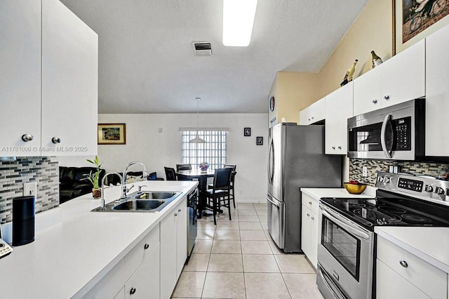 11410 SW 20th St, Miramar, FL 33025 - kitchen featuring stainless steel appliances, light countertops, tasteful backsplash, and white cabinets