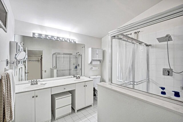 11410 SW 20th St, Miramar, FL 33025 - bathroom featuring a shower, double vanity, tile patterned flooring, and vaulted ceiling