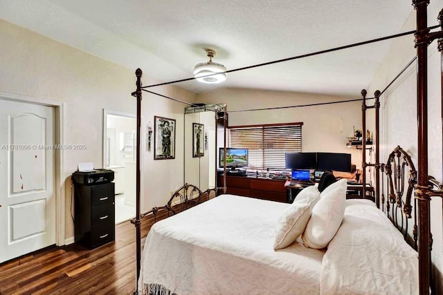 bedroom with connected bathroom, a ceiling fan, wood finished floors, and lofted ceiling