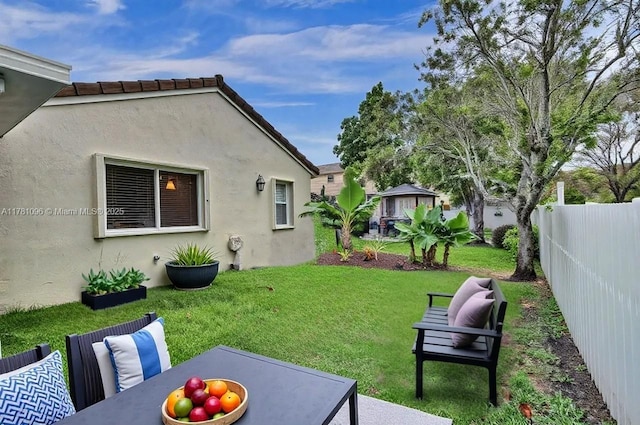 view of yard with fence and a patio