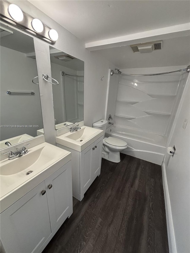 full bathroom featuring two vanities, visible vents, a sink, and wood finished floors
