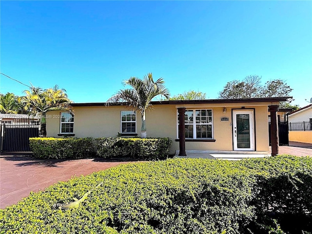 single story home with stucco siding and fence