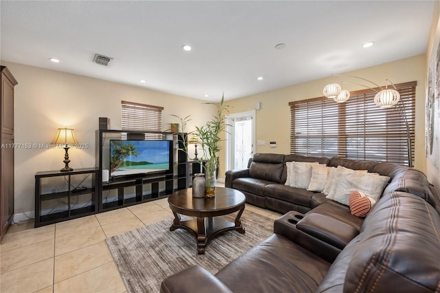 living room with light tile patterned floors, visible vents, and recessed lighting