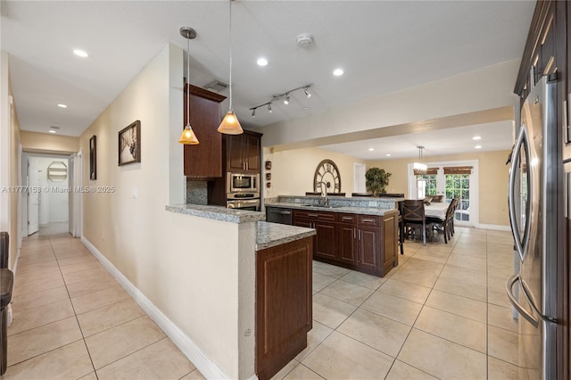 kitchen featuring a peninsula, light tile patterned flooring, visible vents, appliances with stainless steel finishes, and a sink