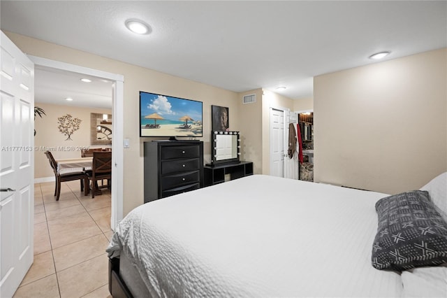 bedroom featuring light tile patterned floors, baseboards, visible vents, and recessed lighting