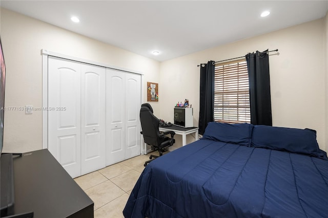 bedroom featuring light tile patterned floors, recessed lighting, and a closet