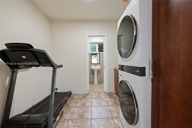 laundry room with stacked washing maching and dryer and laundry area