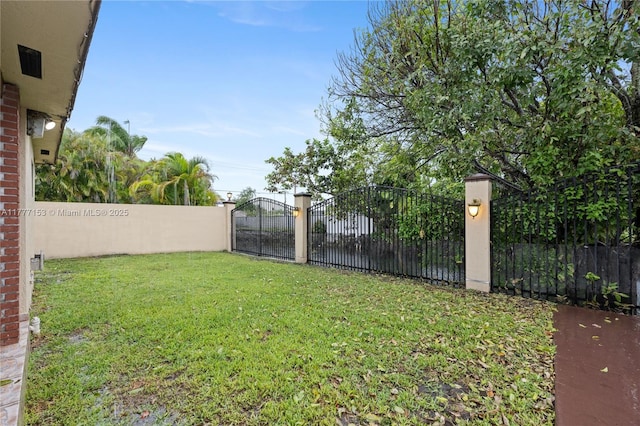 view of yard with fence and a gate