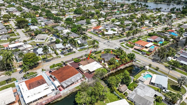 drone / aerial view featuring a water view and a residential view