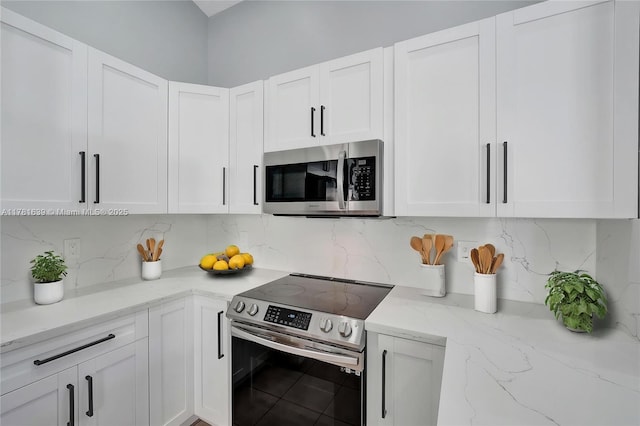 kitchen featuring backsplash, white cabinets, and appliances with stainless steel finishes