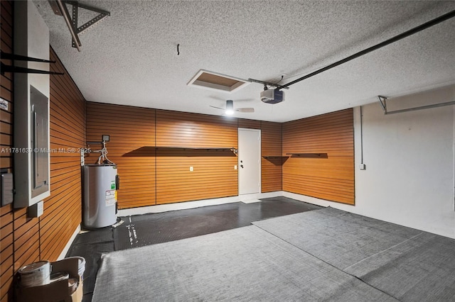 garage featuring electric water heater and a garage door opener