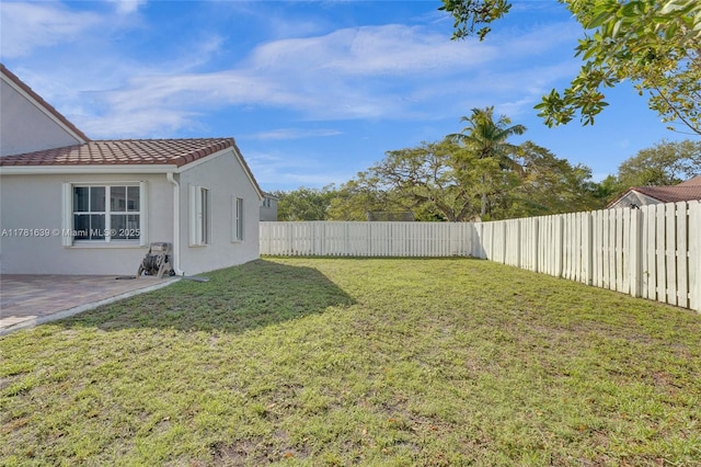 view of yard featuring a patio and a fenced backyard