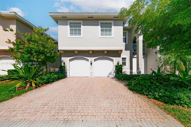 4981 SW 173rd Ave, Miramar, FL 33029 - view of front facade featuring stucco siding, decorative driveway, and a garage