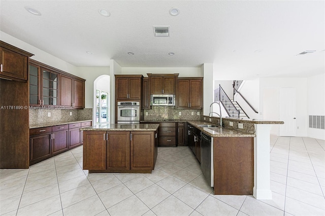 4981 SW 173rd Ave, Miramar, FL 33029 - kitchen featuring appliances with stainless steel finishes, a sink, backsplash, a peninsula, and recessed lighting
