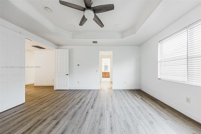 4981 SW 173rd Ave, Miramar, FL 33029 - unfurnished bedroom with a raised ceiling, light wood-type flooring, and baseboards