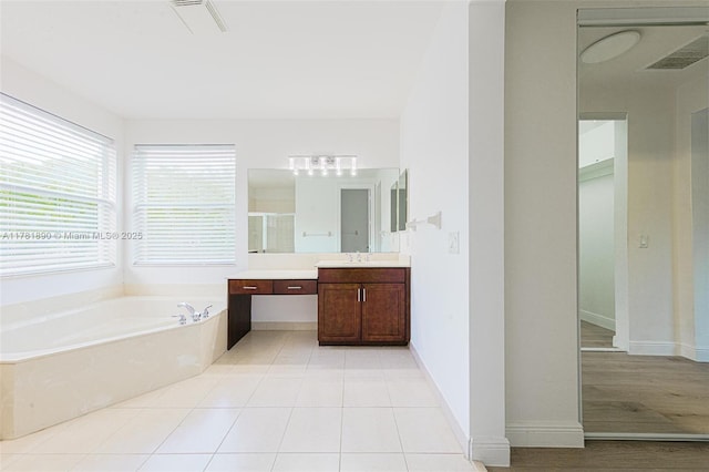 4981 SW 173rd Ave, Miramar, FL 33029 - full bath featuring vanity, a garden tub, a stall shower, and baseboards