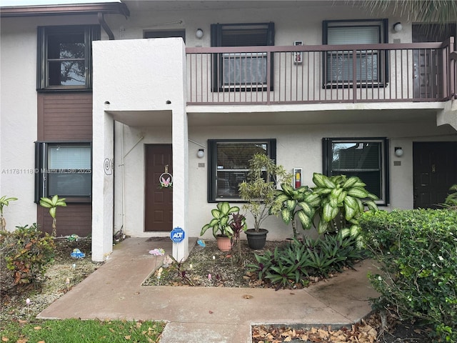 9968 Nob Hill Ct Unit 9968, Sunrise, FL 33351 - view of exterior entry featuring a balcony and stucco siding