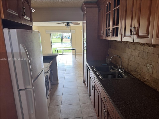 9968 Nob Hill Ct Unit 9968, Sunrise, FL 33351 - kitchen featuring freestanding refrigerator, a sink, ceiling fan, light tile patterned flooring, and backsplash