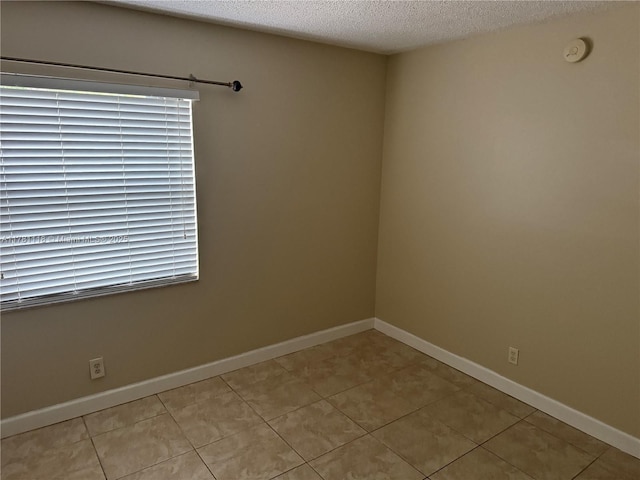 9968 Nob Hill Ct Unit 9968, Sunrise, FL 33351 - unfurnished room with light tile patterned flooring, a textured ceiling, baseboards, and a smoke detector