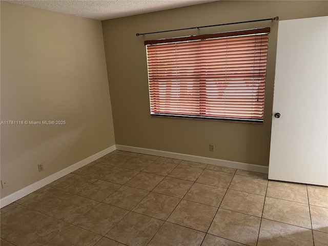 9968 Nob Hill Ct Unit 9968, Sunrise, FL 33351 - tiled spare room featuring a textured ceiling and baseboards
