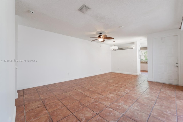 1551 Seagrape Way, Hollywood, FL 33019 - unfurnished room with baseboards, a ceiling fan, a textured ceiling, and visible vents