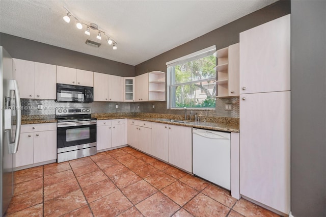 1551 Seagrape Way, Hollywood, FL 33019 - kitchen with backsplash, visible vents, open shelves, a sink, and stainless steel appliances