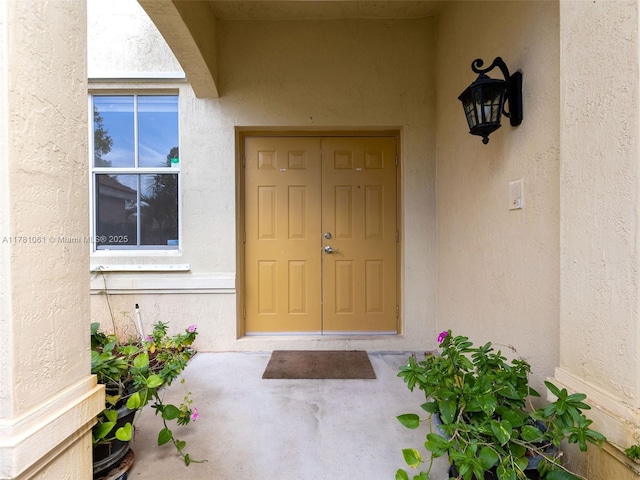 doorway to property with stucco siding