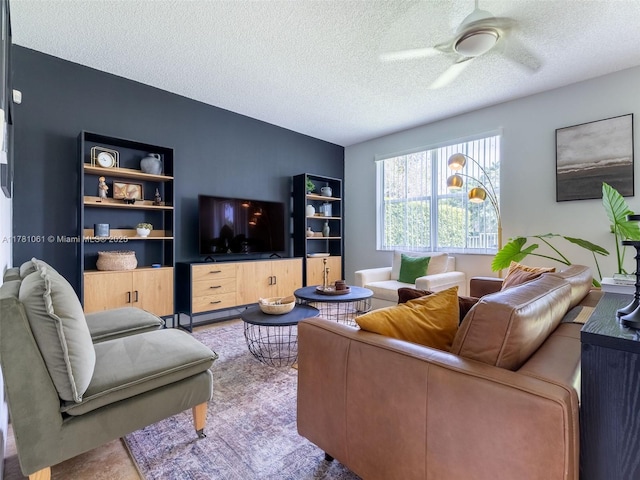 living area featuring a textured ceiling and ceiling fan