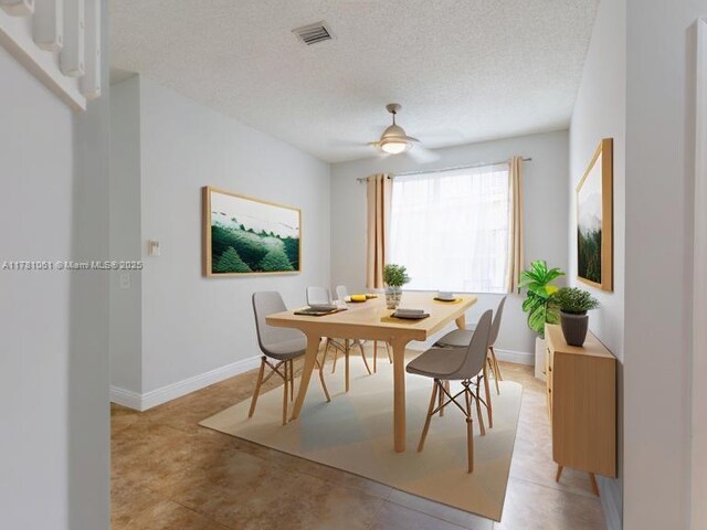 dining space with a textured ceiling, visible vents, baseboards, and ceiling fan