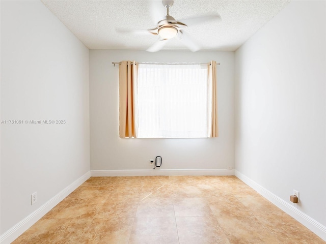 unfurnished room featuring a textured ceiling, a ceiling fan, and baseboards