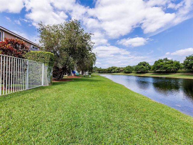 view of yard featuring fence and a water view