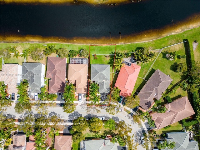 birds eye view of property with a water view and a residential view