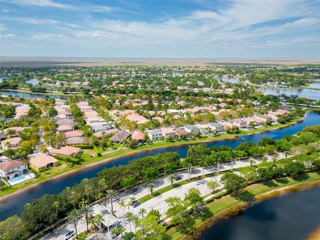 birds eye view of property with a water view and a residential view