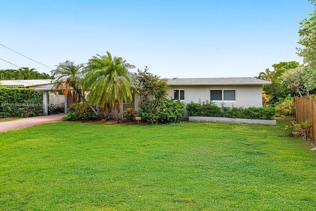 509 NE 29th St, Wilton Manors, FL 33334 - view of front of home with stucco siding, driveway, and an attached carport