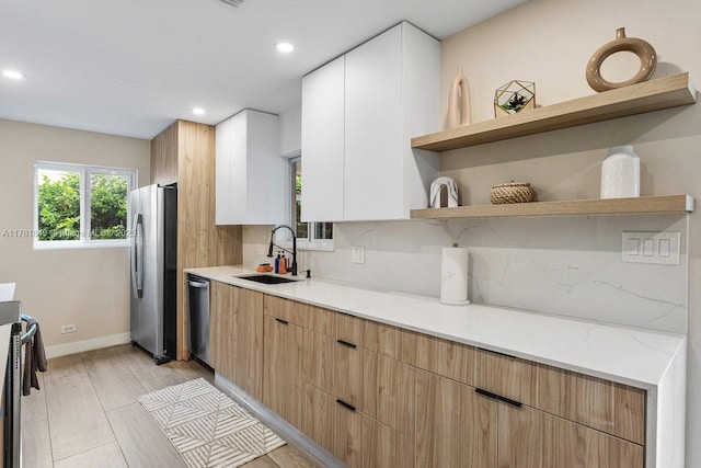 509 NE 29th St, Wilton Manors, FL 33334 - kitchen with appliances with stainless steel finishes, open shelves, recessed lighting, decorative backsplash, and white cabinets