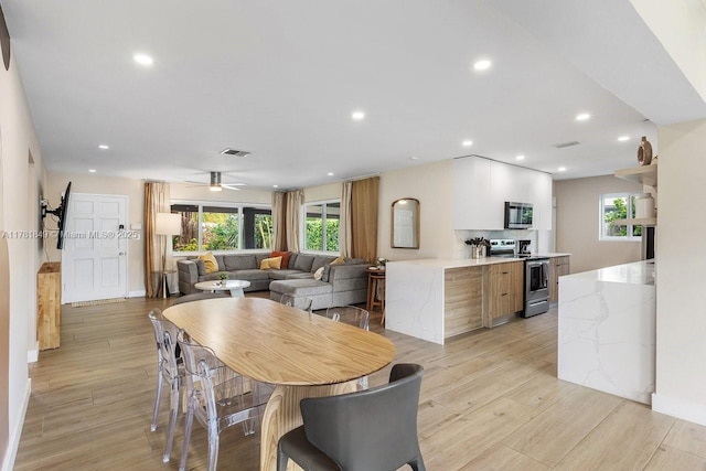 509 NE 29th St, Wilton Manors, FL 33334 - dining area featuring light wood finished floors, a ceiling fan, and recessed lighting