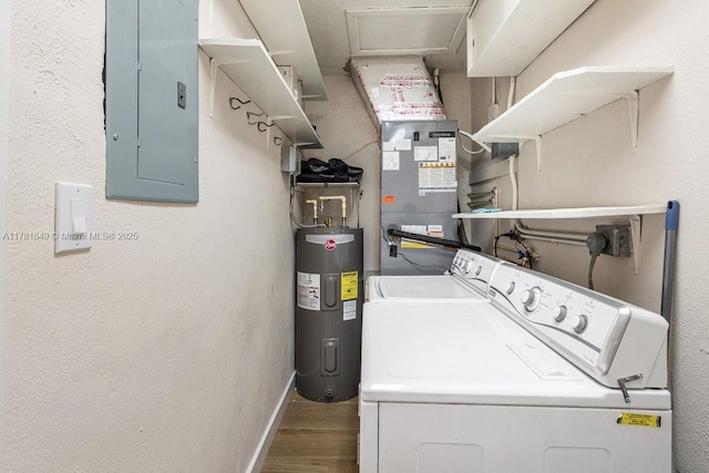 509 NE 29th St, Wilton Manors, FL 33334 - laundry area featuring water heater, electric panel, washing machine and dryer, and wood finished floors