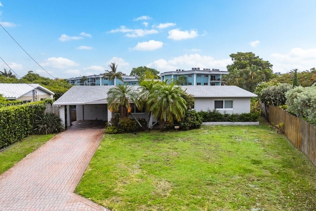 509 NE 29th St, Wilton Manors, FL 33334 - view of front of home featuring decorative driveway, a carport, and stucco siding