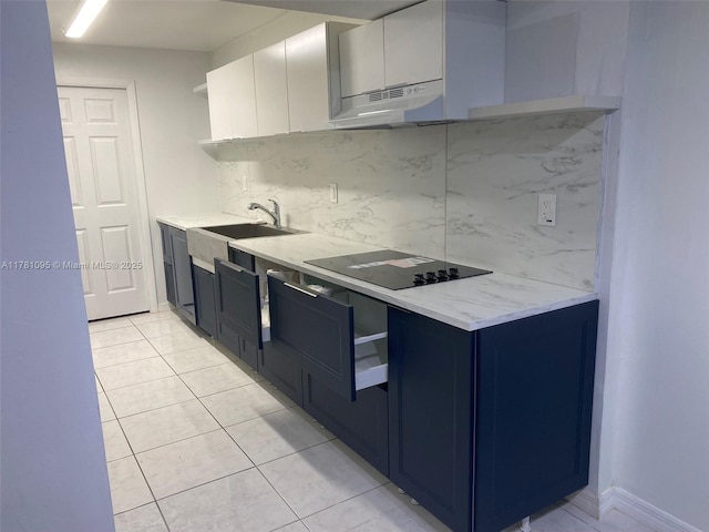kitchen featuring open shelves, under cabinet range hood, a sink, black electric stovetop, and decorative backsplash
