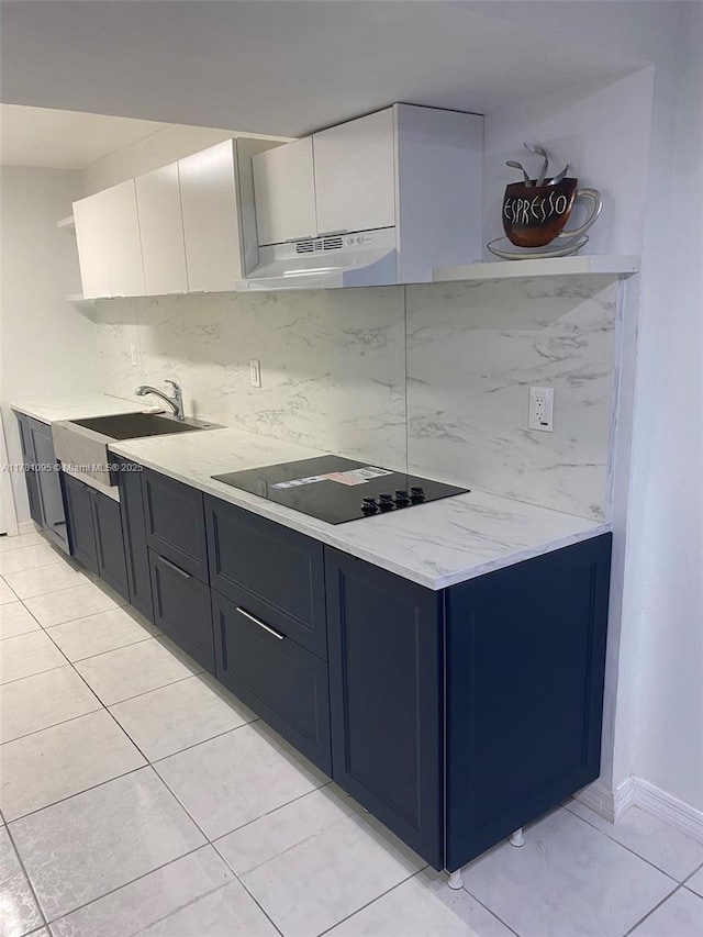 kitchen with open shelves, black electric cooktop, under cabinet range hood, decorative backsplash, and a sink